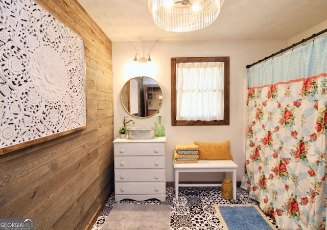 bathroom featuring wood walls and vanity