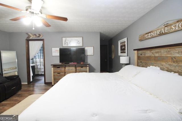 bedroom featuring a textured ceiling, ceiling fan, and dark hardwood / wood-style flooring