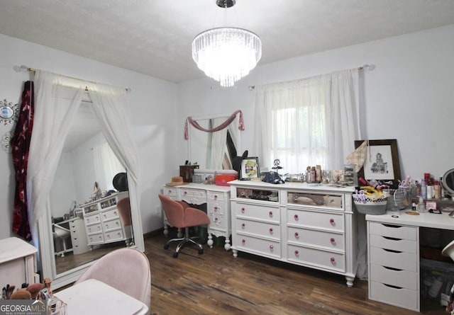 office area with a notable chandelier and dark wood-type flooring