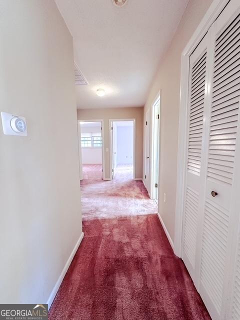 hallway featuring carpet