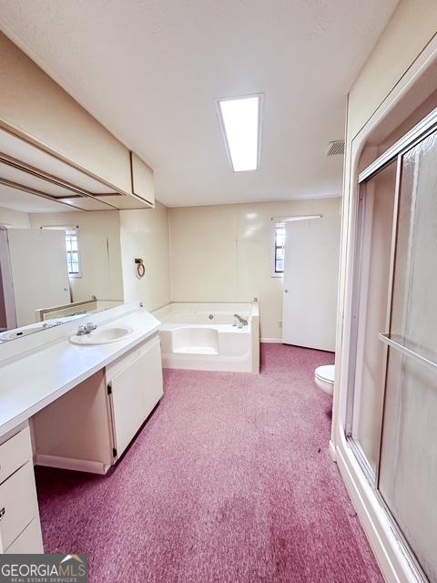 full bathroom with vanity, toilet, and independent shower and bath