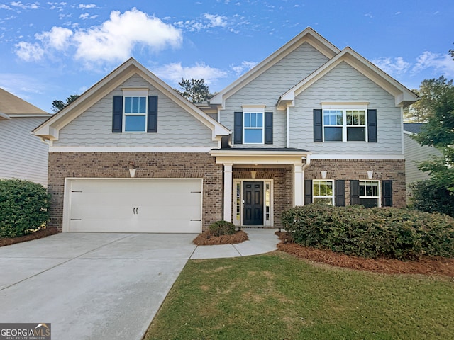 craftsman-style home featuring a garage and a front yard