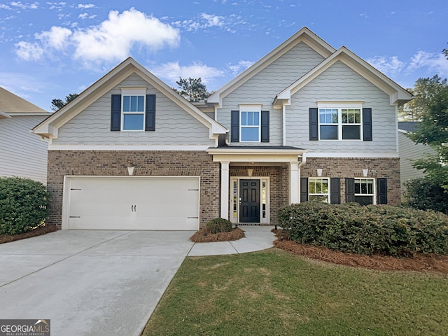 craftsman-style home with a garage, brick siding, driveway, and a front lawn