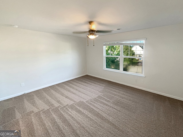 empty room with ceiling fan and carpet