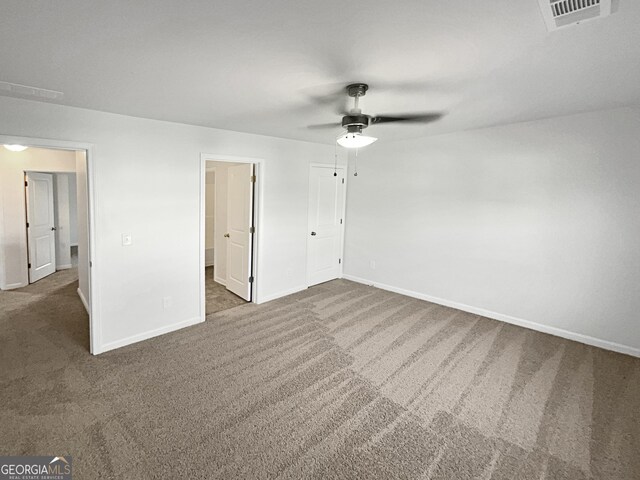 spare room with ceiling fan and carpet flooring