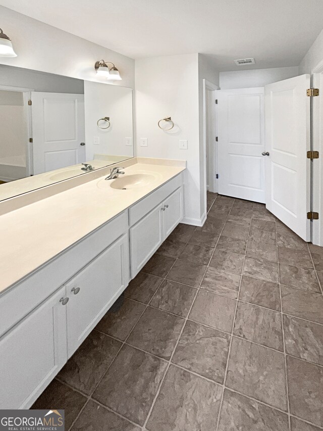 bathroom featuring tile patterned flooring and vanity