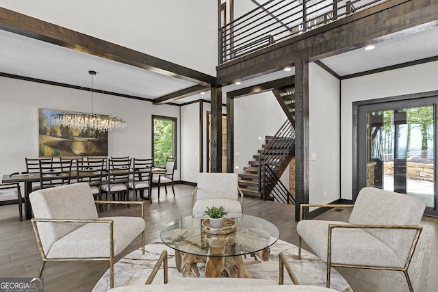 living room with beamed ceiling, hardwood / wood-style flooring, a chandelier, and a wealth of natural light