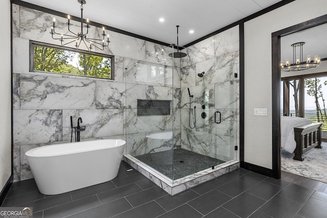 bathroom featuring tile walls, separate shower and tub, a notable chandelier, and tile patterned flooring