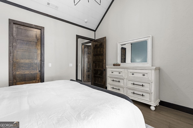 bedroom featuring lofted ceiling and dark hardwood / wood-style floors