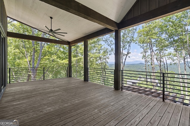 wooden terrace featuring a mountain view and ceiling fan