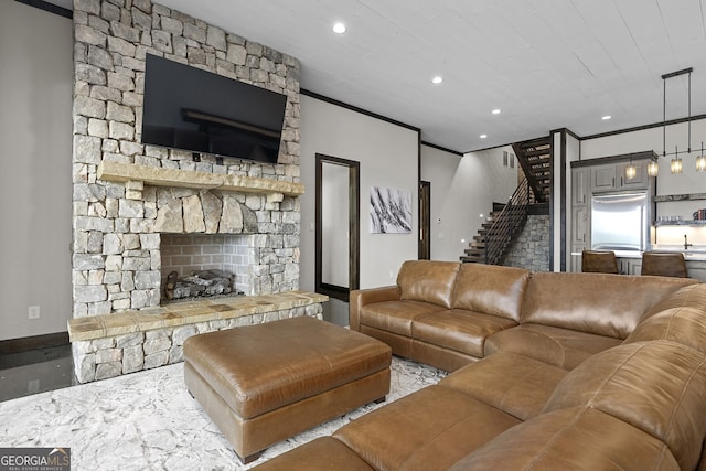 living room featuring ornamental molding and a fireplace