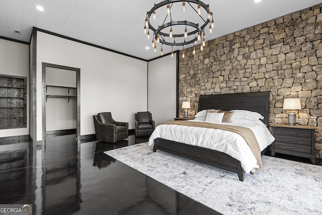 bedroom featuring crown molding, a notable chandelier, a walk in closet, and a closet