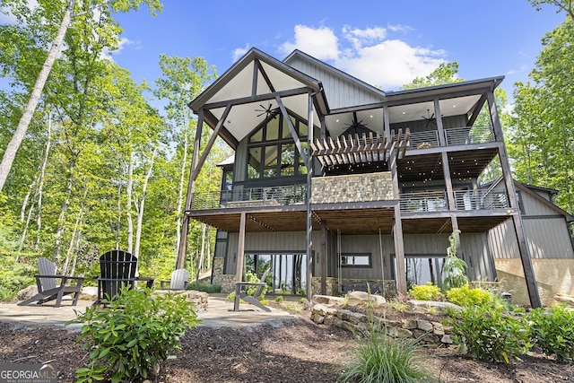 rear view of house featuring a patio and a balcony