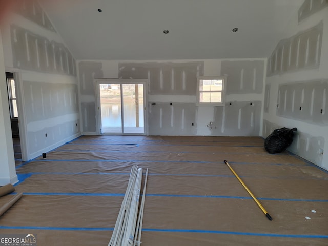 unfurnished living room with lofted ceiling