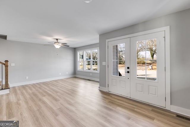 entryway with french doors, light wood-type flooring, visible vents, and baseboards