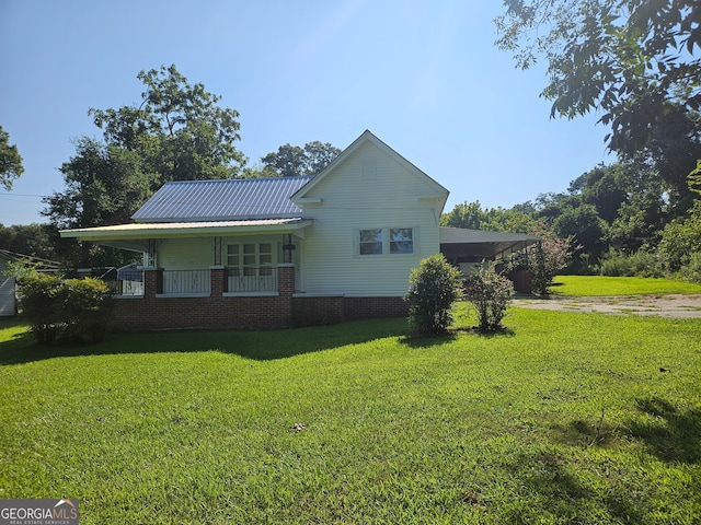 view of home's exterior featuring covered porch and a yard