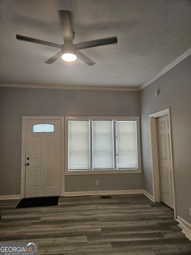 entryway with ceiling fan, crown molding, and wood-type flooring