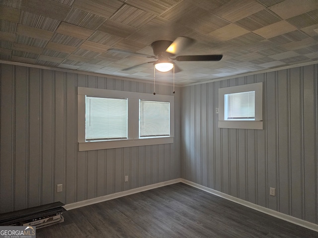 unfurnished room featuring ceiling fan and dark wood-type flooring