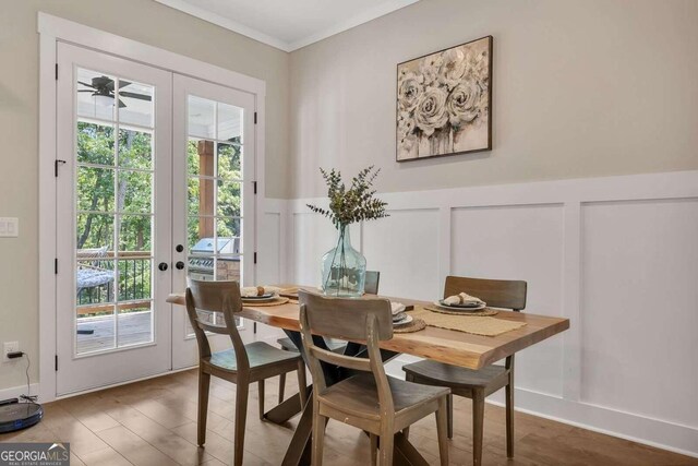 dining area featuring french doors, ornamental molding, and hardwood / wood-style flooring