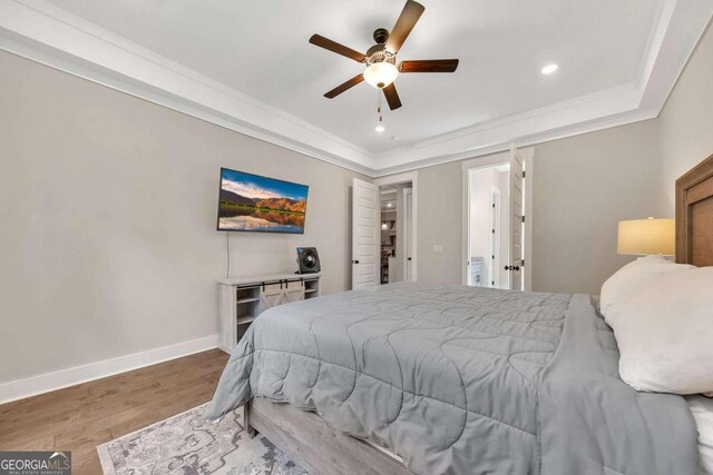 bedroom featuring ceiling fan, ornamental molding, and hardwood / wood-style floors