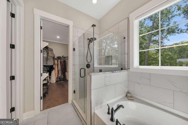 bathroom featuring separate shower and tub