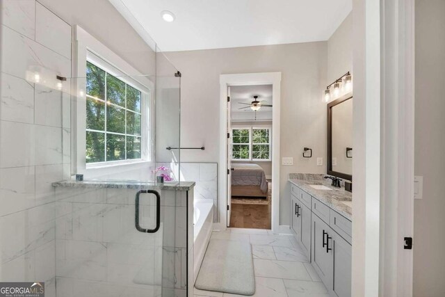 bathroom with ceiling fan, wood-type flooring, vanity, and a healthy amount of sunlight