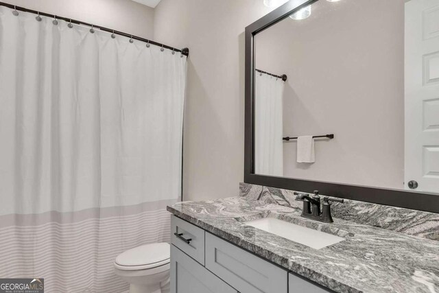 bathroom featuring vanity and toilet