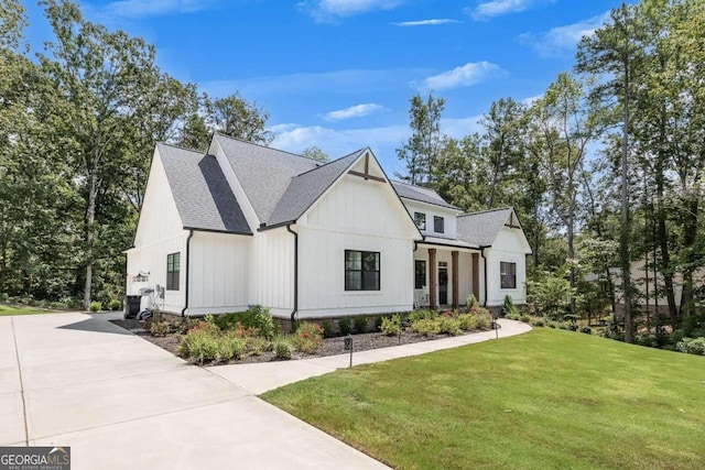 modern farmhouse style home with a front yard