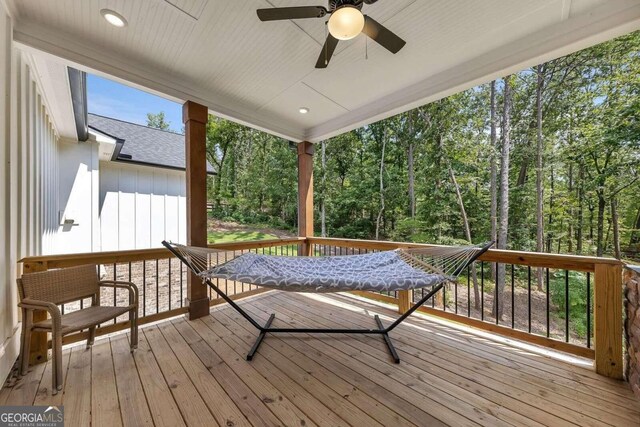 wooden terrace featuring ceiling fan