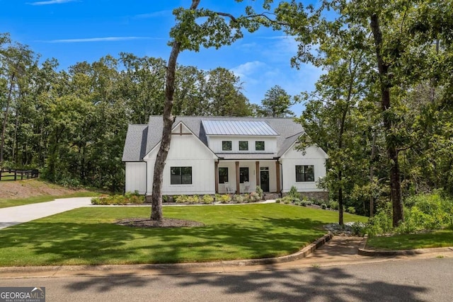 modern inspired farmhouse featuring a front lawn