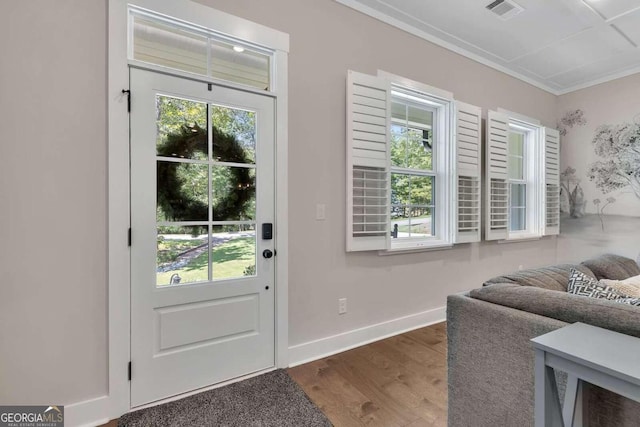 entryway with ornamental molding, dark hardwood / wood-style flooring, and a healthy amount of sunlight