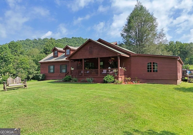 rear view of house with a yard