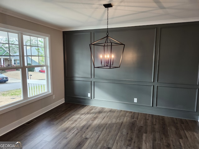 unfurnished dining area featuring a healthy amount of sunlight, a notable chandelier, dark hardwood / wood-style flooring, and crown molding