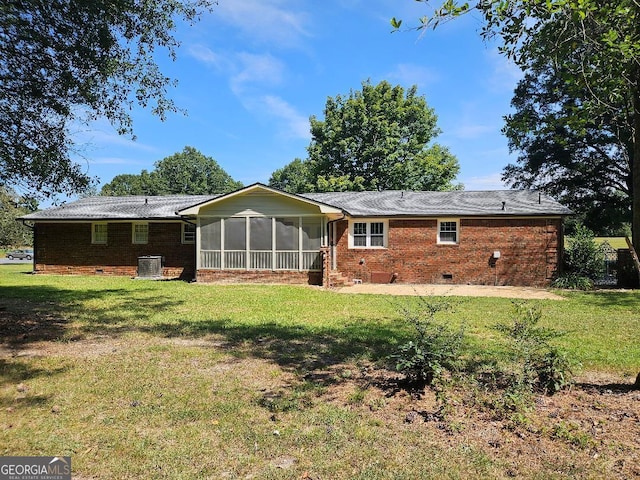 back of property with a sunroom, cooling unit, and a yard