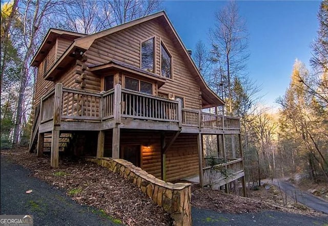 back of property with a wooden deck