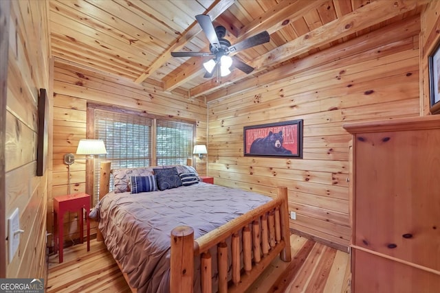 bedroom with wood ceiling, wood walls, beam ceiling, and light hardwood / wood-style floors