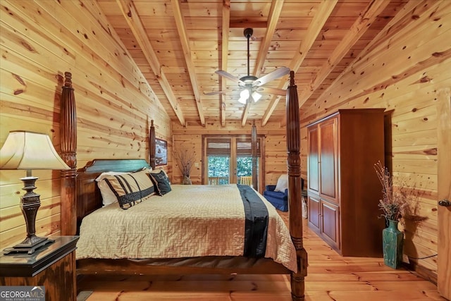 bedroom with vaulted ceiling with beams, wood walls, light wood-type flooring, and wooden ceiling