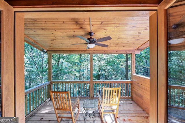 wooden deck featuring ceiling fan