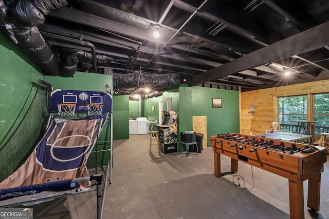 playroom with concrete floors and washing machine and dryer