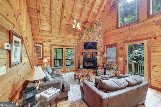 living room featuring light wood-type flooring, wooden ceiling, and wooden walls