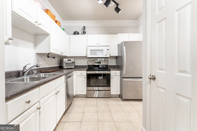 kitchen with appliances with stainless steel finishes, ornamental molding, sink, and white cabinets