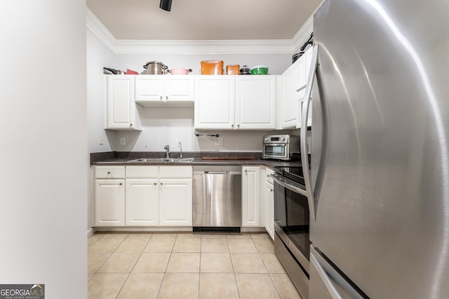 kitchen featuring white cabinets, light tile patterned floors, sink, stainless steel appliances, and crown molding