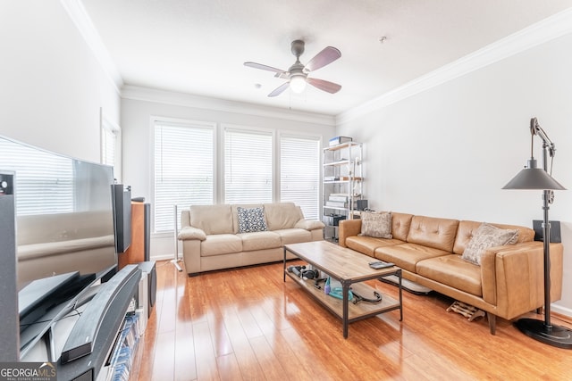 living room featuring wood-type flooring, ornamental molding, and ceiling fan