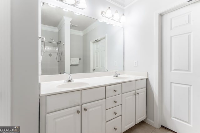 bathroom featuring tile patterned flooring, a shower, vanity, and crown molding