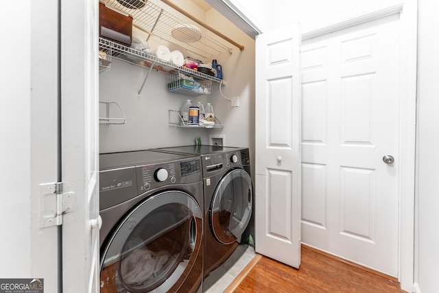 washroom with separate washer and dryer and light wood-type flooring