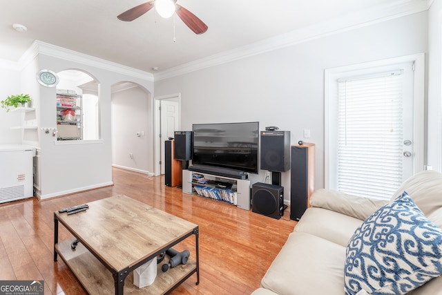 living room with ceiling fan, hardwood / wood-style flooring, and crown molding