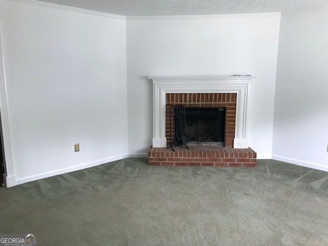 unfurnished living room with crown molding, carpet flooring, and a fireplace