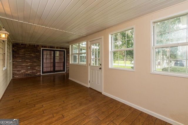 unfurnished sunroom with plenty of natural light and wood ceiling