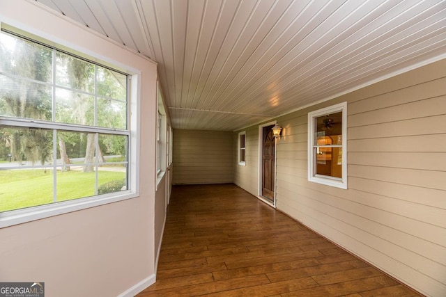 hall featuring hardwood / wood-style flooring and wood ceiling