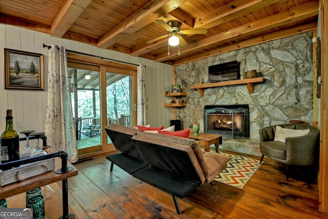 living room featuring ceiling fan, a fireplace, wood-type flooring, and wood ceiling